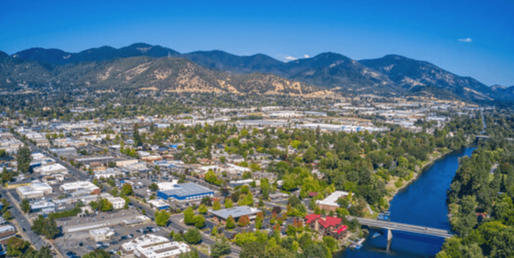 Construction worker using silicone sealant caulk for repair leaked inside window frame.